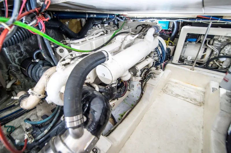 Slide: The Image of Engine room of 1999 Riviera 43 Open Flybridge with visible machinery and wiring. - 33