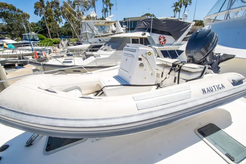 Slide: The Image of Inflatable boat on 1999 Riviera 43 Open Flybridge yacht, docked in marina. - 34
