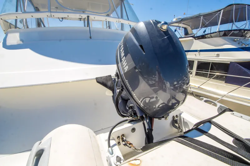 Slide: The Image of 1999 Riviera 43 Open Flybridge with Yamaha outboard motor, docked under clear blue sky. - 35