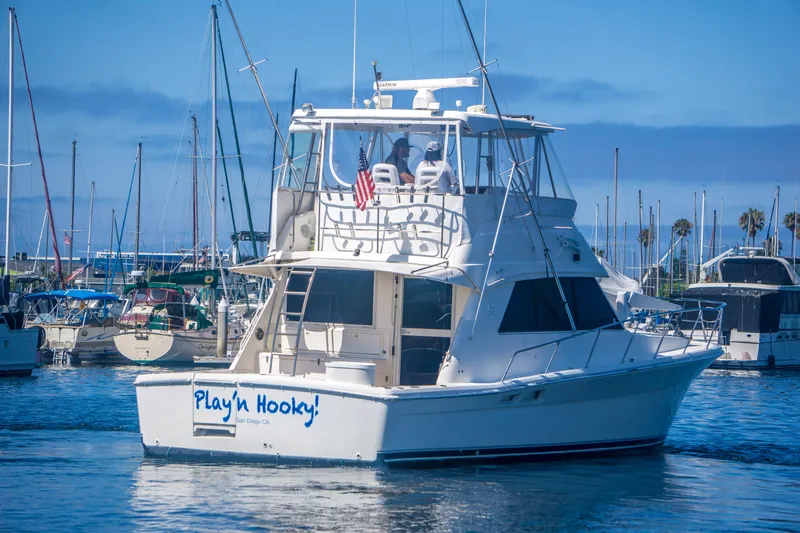 Slide: The Image of 1999 Riviera 43 Open Flybridge yacht in marina, "Play'n Hooky" on stern. - 5