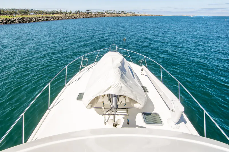 Slide: The Image of Bow view of 1999 Riviera 43 Open Flybridge yacht on open water. - 7