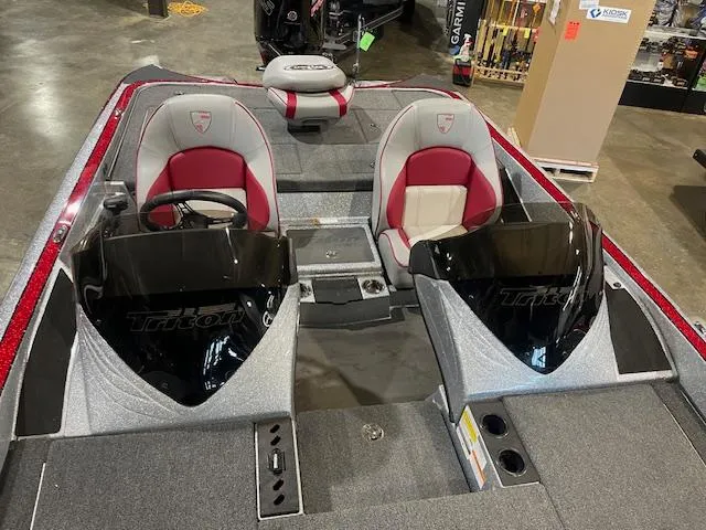 Slide: The Image of 2023 Triton 20 TRX Patriot boat interior with dual consoles and red-accented seats. - 10