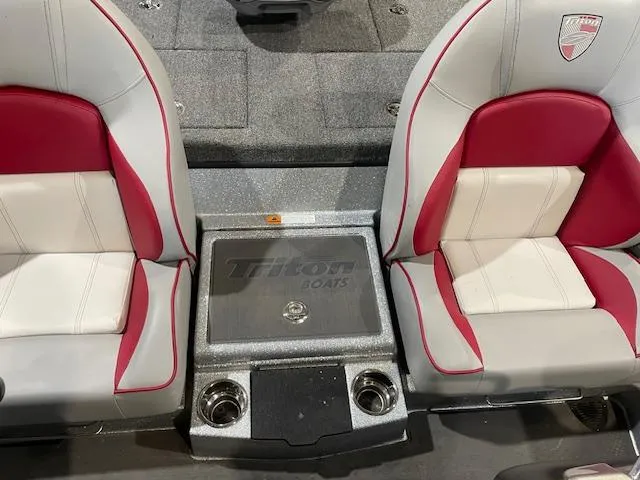 Slide: The Image of 2023 Triton 20 TRX Patriot boat interior with red and white seats, center console. - 11