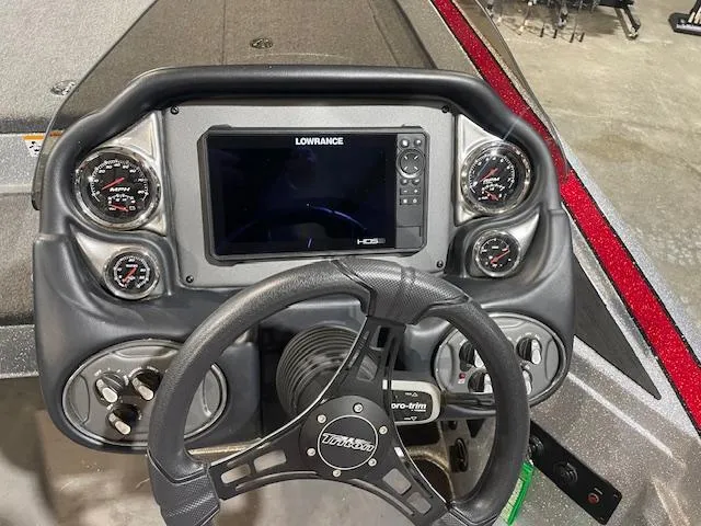 Slide: The Image of 2023 Triton 20 TRX Patriot boat dashboard with Lowrance display and gauges. - 12