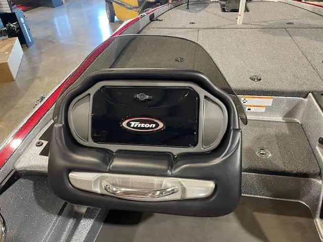 Slide: The Image of 2023 Triton 20 TRX Patriot boat dashboard with logo and control panel. - 13
