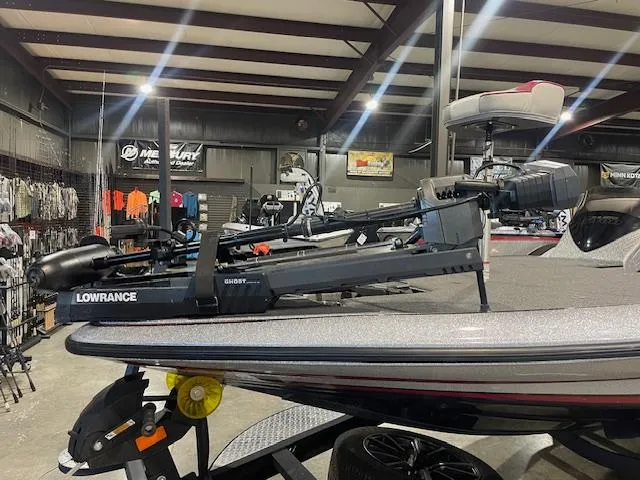 Slide: The Image of 2023 Triton 20 TRX Patriot boat with Lowrance equipment in a showroom. - 3