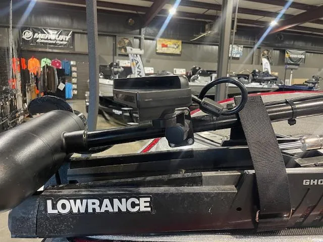 Slide: The Image of 2023 Triton 20 TRX Patriot with Lowrance equipment in a showroom. - 4