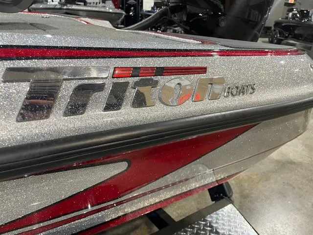 Slide: The Image of 2023 Triton 20 TRX Patriot boat with metallic finish and logo detail. - 6