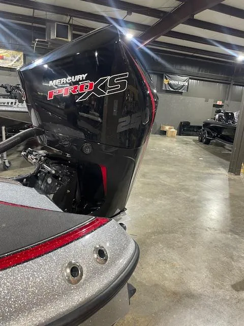 Slide: The Image of 2023 Triton 20 TRX Patriot with Mercury Pro XS engine in a showroom. - 7