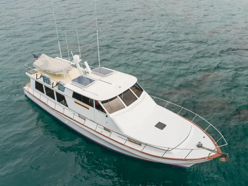 Slide: The Image of 1984 Vic Franck pilothouse yacht on open water, featuring solar panels and sleek design. - 10