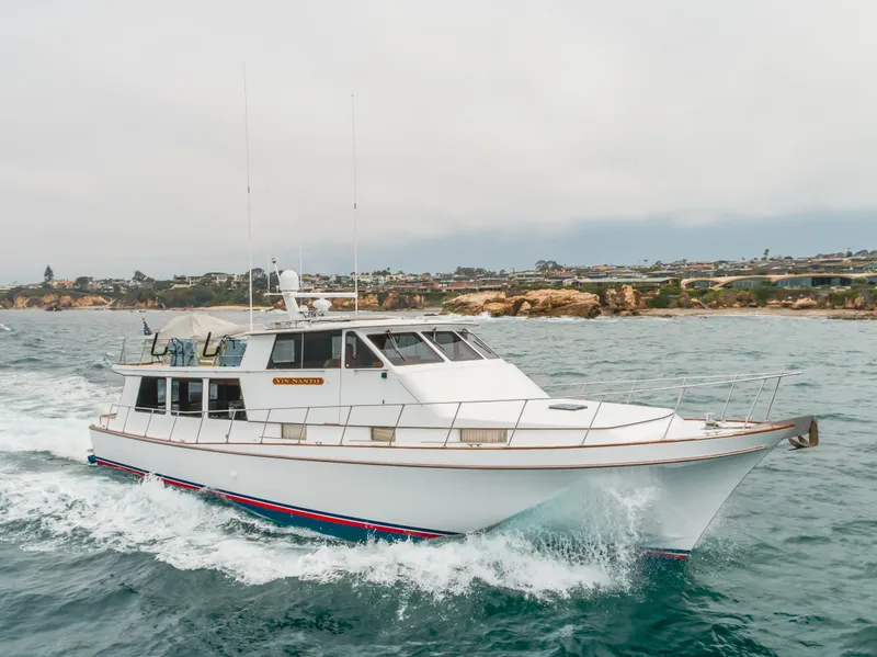 Slide: The Image of 1984 Vic Franck pilothouse yacht cruising on the ocean near rocky coastline. - 12