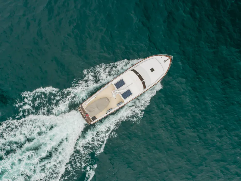Slide: The Image of Aerial view of 1984 Vic Franck pilothouse yacht cruising on open water. - 22