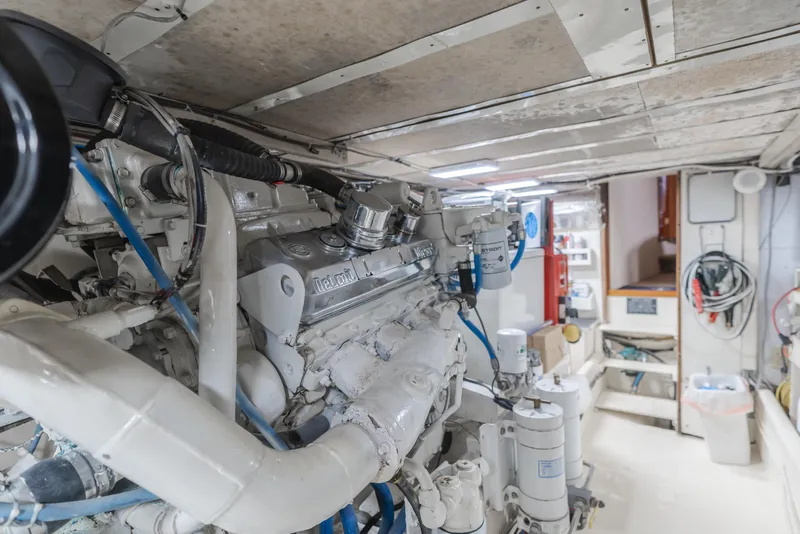 Slide: The Image of Engine room of a 1984 Vic Franck pilothouse yacht, showcasing mechanical components and equipment. - 26