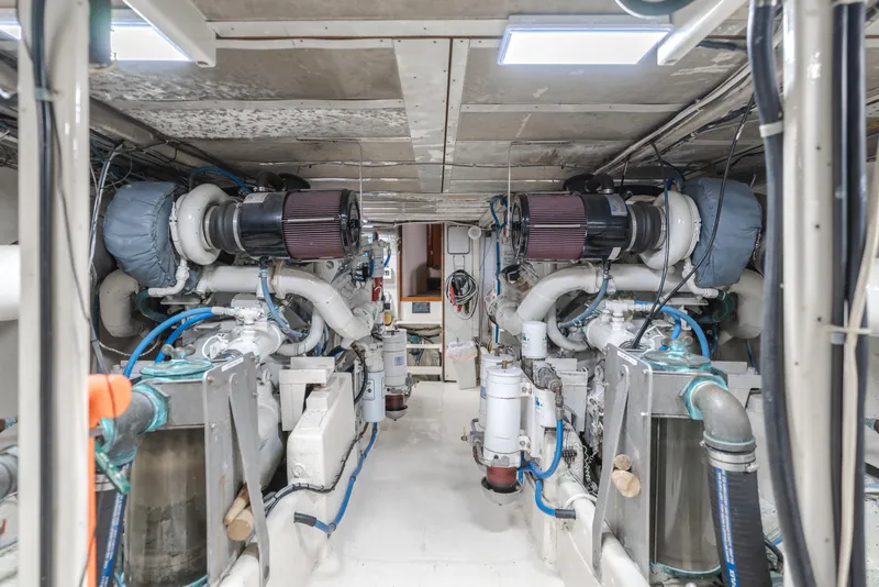 Slide: The Image of Engine room of a 1984 Vic Franck pilothouse yacht, showcasing dual engines and mechanical systems. - 29