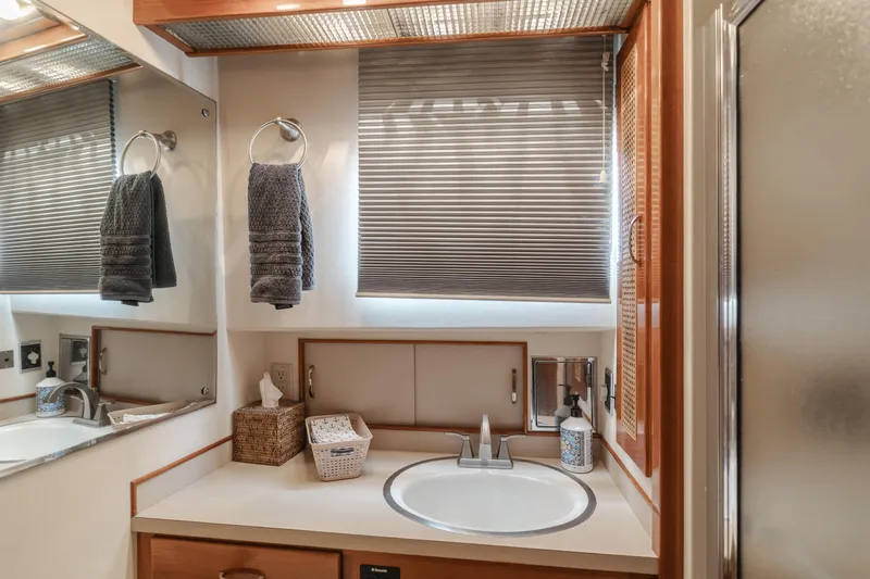 Slide: The Image of 1984 Vic Franck pilothouse bathroom with sink, mirror, and towels. - 40
