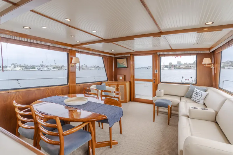Slide: The Image of Luxurious 1984 Vic Franck pilothouse interior with elegant dining area and waterfront views. - 44