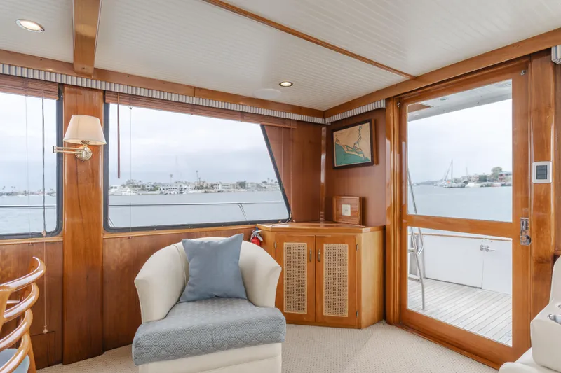 Slide: The Image of 1984 Vic Franck pilothouse interior with elegant wood paneling and waterfront view. - 46