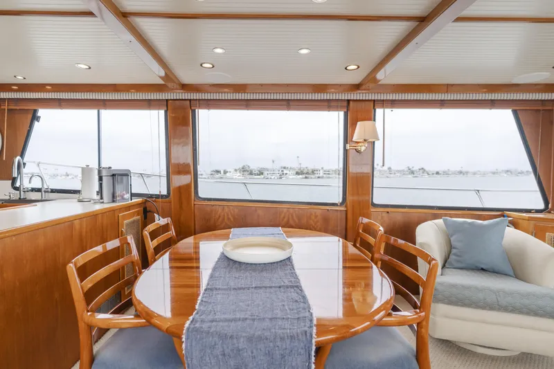 Slide: The Image of Luxurious 1984 Vic Franck pilothouse interior with wooden dining table and panoramic windows. - 47