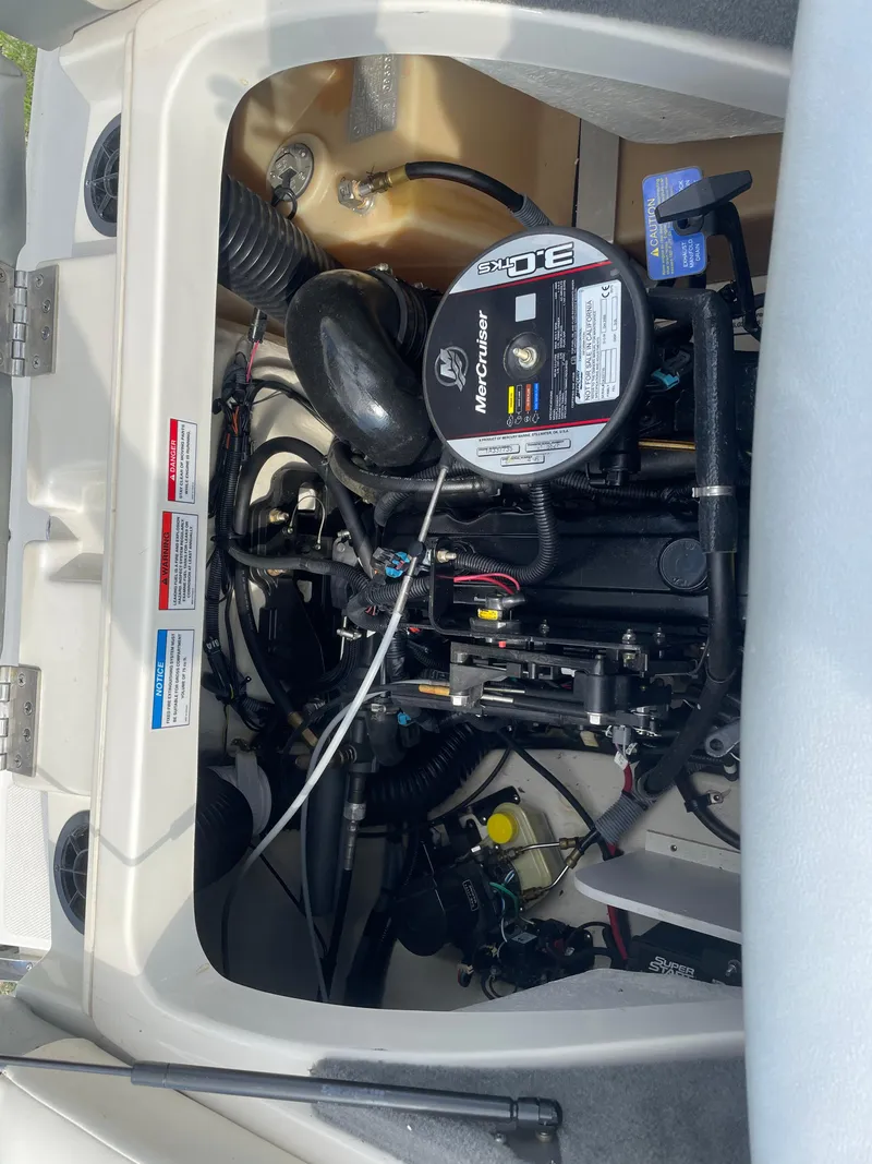 Slide: The Image of Engine compartment of a 2009 Sea Ray 175 Sport boat, featuring a MerCruiser 3.0L engine. - 13