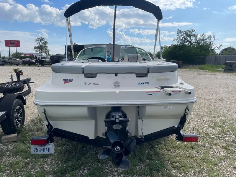 Slide: The Image of 2009 Sea Ray 175 Sport boat with trailer, rear view, parked outdoors. - 6
