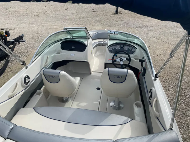 Slide: The Image of 2009 Sea Ray 175 Sport boat interior with steering wheel and seating. - 7