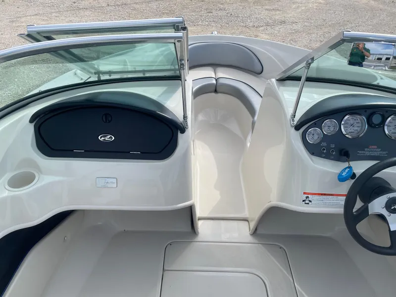 Slide: The Image of 2009 Sea Ray 175 Sport boat interior with dashboard and seating area. - 8