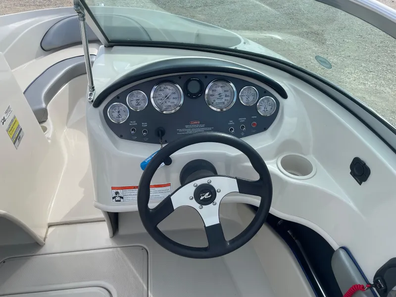 Slide: The Image of 2009 Sea Ray 175 Sport dashboard with steering wheel and gauges. - 9