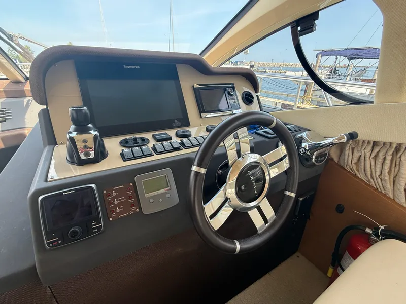 Slide: The Image of Helm of 2018 Azimut 42 Fly yacht with modern navigation controls and steering wheel. - 11