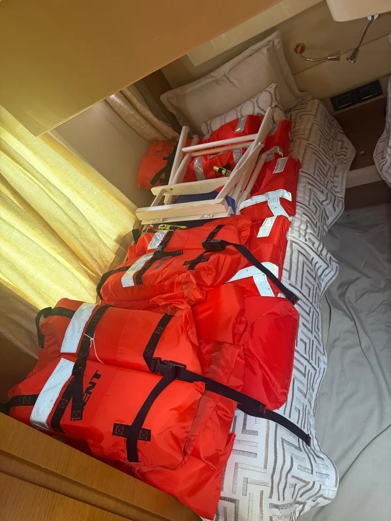 Slide: The Image of Life jackets and ladder on bed inside 2018 Azimut 42 Fly yacht cabin. - 18