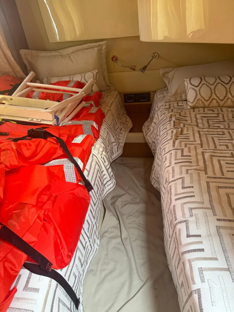 Slide: The Image of Twin beds in Azimut 42 Fly 2018 cabin with life jackets and ladder. - 19