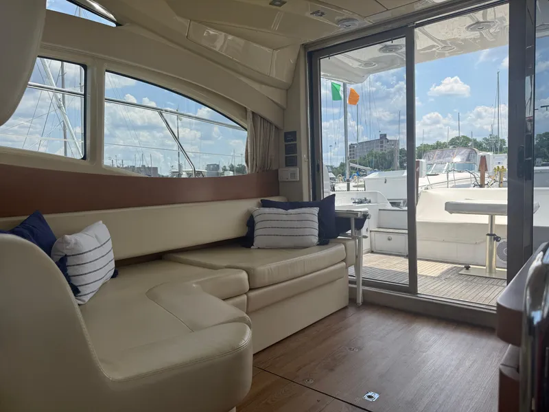 Slide: The Image of Luxurious interior of 2018 Azimut 42 Fly yacht with plush seating and scenic marina view. - 20