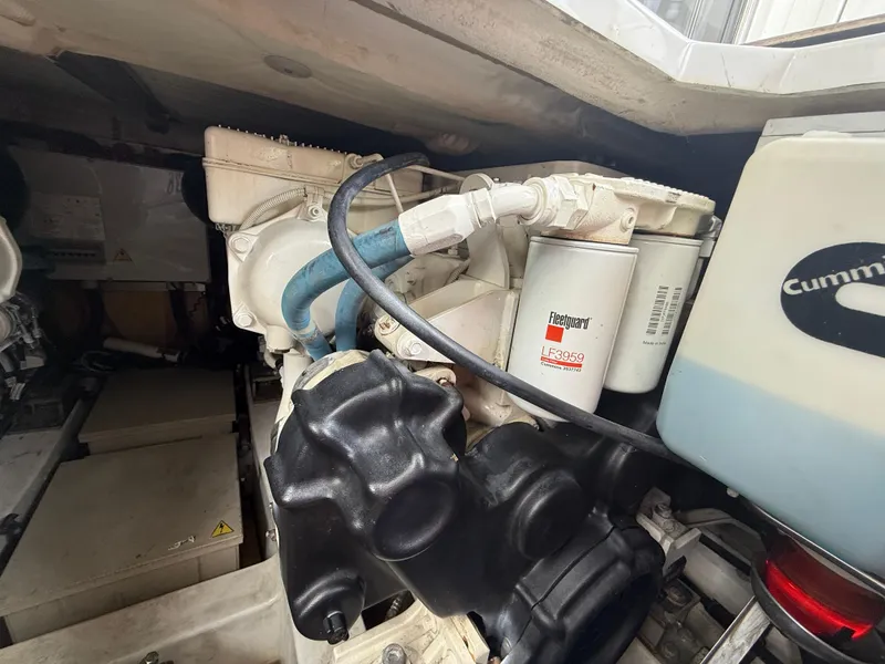 Slide: The Image of Engine compartment of a 2018 Azimut 42 Fly yacht, featuring Cummins components and Fleetguard filters. - 27