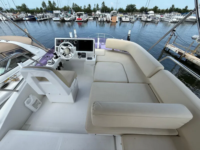 Slide: The Image of Flybridge of 2018 Azimut 42 Fly yacht with helm and seating, docked at marina. - 30
