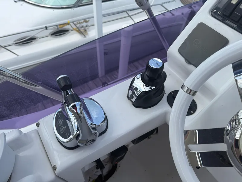 Slide: The Image of Control panel of a 2018 Azimut 42 Fly yacht with steering wheel and throttle. - 31