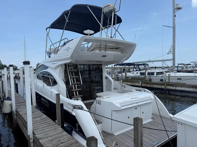 Slide: The Image of 2018 Azimut 42 Fly yacht docked at marina, featuring sleek design and flybridge. - 37