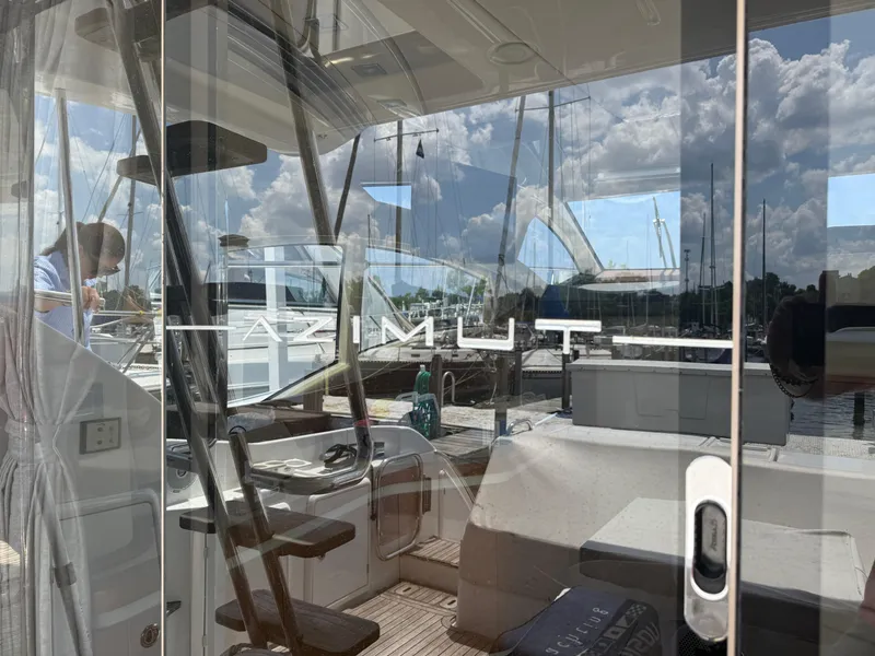 Slide: The Image of Azimut 42 Fly 2018 yacht interior with marina reflection on glass door. - 4