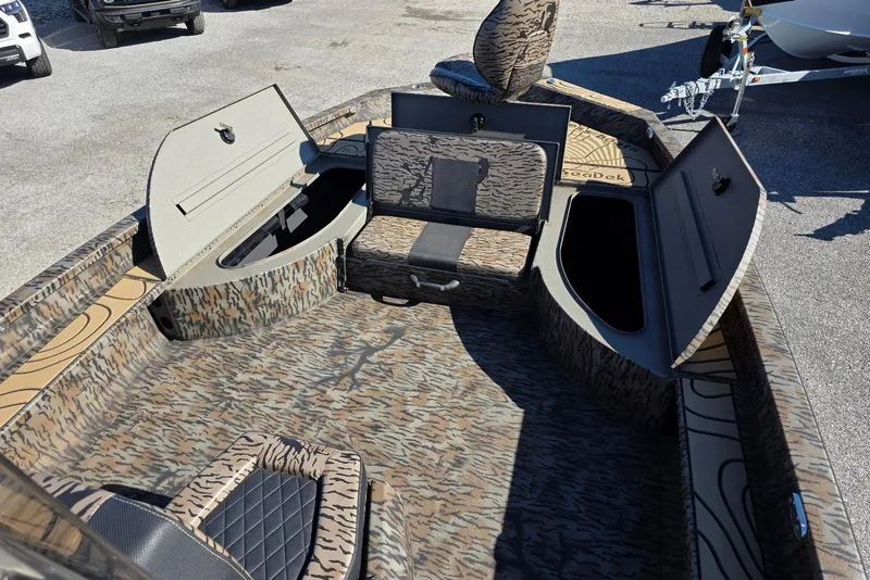 Slide: The Image of 2026 Xpress X23 Bay boat interior with camo design and storage compartments open. - 12