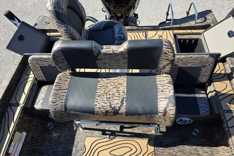Slide: The Image of 2026 Xpress X23 Bay boat interior with patterned seating and storage compartments. - 22