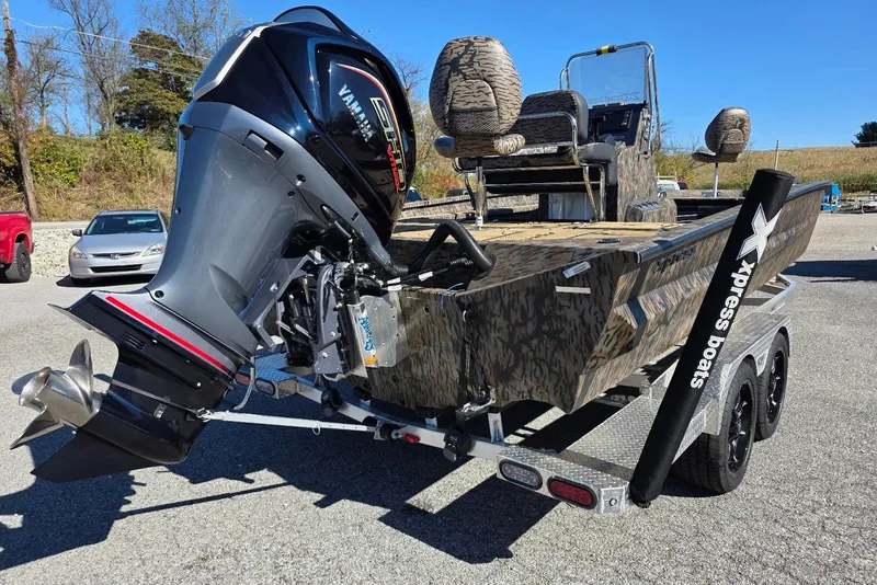 Slide: The Image of 2026 Xpress X23 Bay boat with Yamaha Vmax 250 SHO engine, camo design, on trailer. - 6