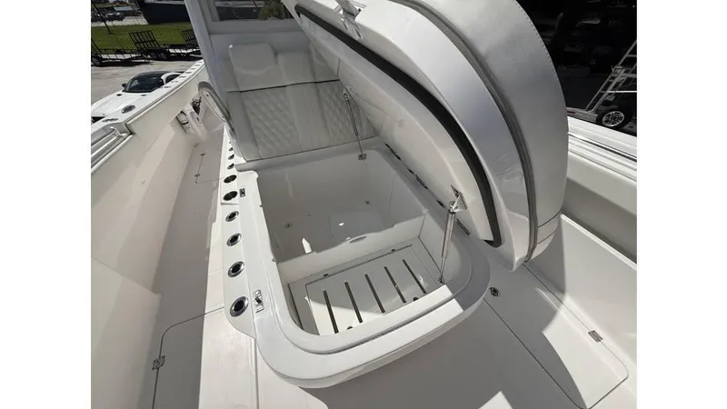 Slide: The Image of Open storage compartment on 2022 Invincible 33 Catamaran boat, showcasing spacious interior design. - 10