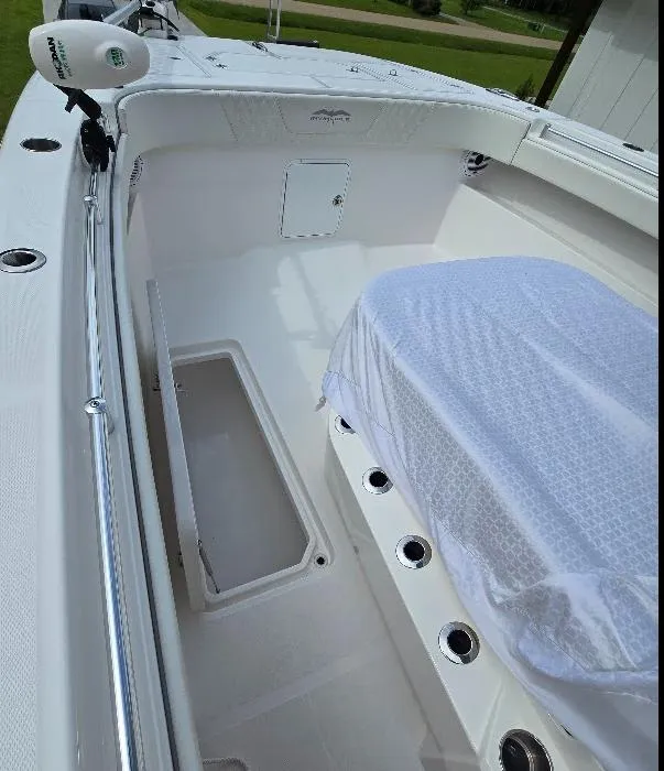 Slide: The Image of 2022 Invincible 33 Catamaran interior with white seating and storage compartments. - 13