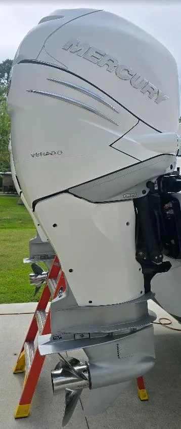 Slide: The Image of 2022 Invincible 33 Catamaran with Mercury outboard engine, displayed outdoors. - 15