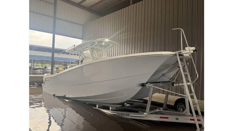 Slide: The Image of 2022 Invincible 33 Catamaran on trailer in covered storage area. - 6