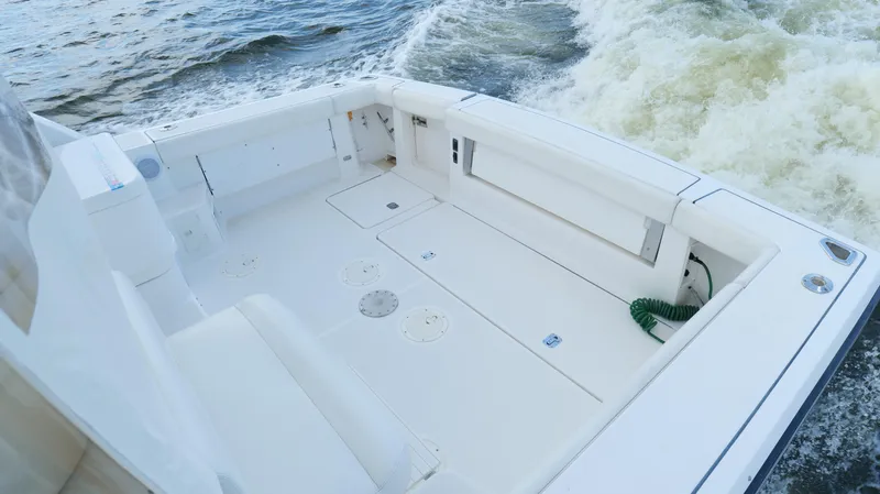 Slide: The Image of 2000 Tiara Yachts 3700 Open boat deck with white seating and ocean waves. - 12