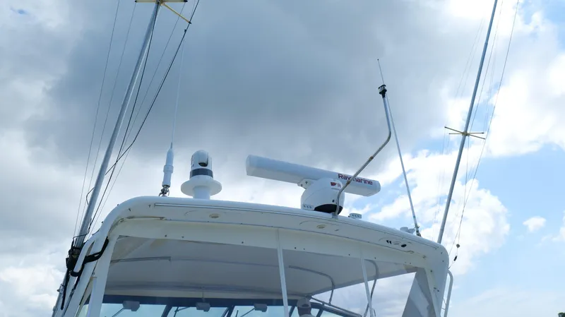 Slide: The Image of Tiara Yachts 3700 Open 2000 model with radar equipment against cloudy sky. - 18