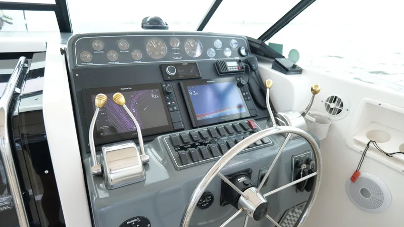 Slide: The Image of Helm of 2000 Tiara Yachts 3700 Open with navigation screens and controls. - 20