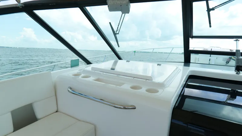 Slide: The Image of Interior view of 2000 Tiara Yachts 3700 Open, featuring seating and ocean backdrop. - 22