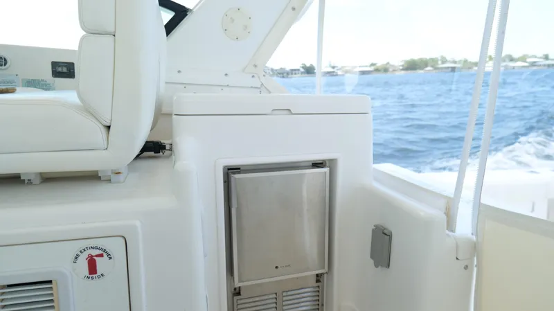 Slide: The Image of 2000 Tiara Yachts 3700 Open interior with seating and fire extinguisher compartment. - 24