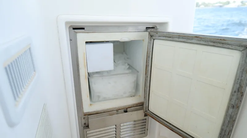 Slide: The Image of Ice maker on 2000 Tiara Yachts 3700 Open, with open door and visible ice inside. - 26