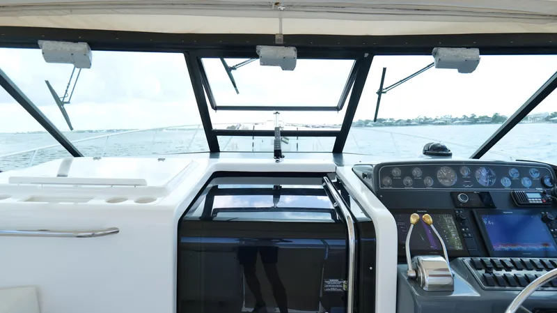 Slide: The Image of Cockpit view of 2000 Tiara Yachts 3700 Open, showcasing controls and ocean horizon. - 27